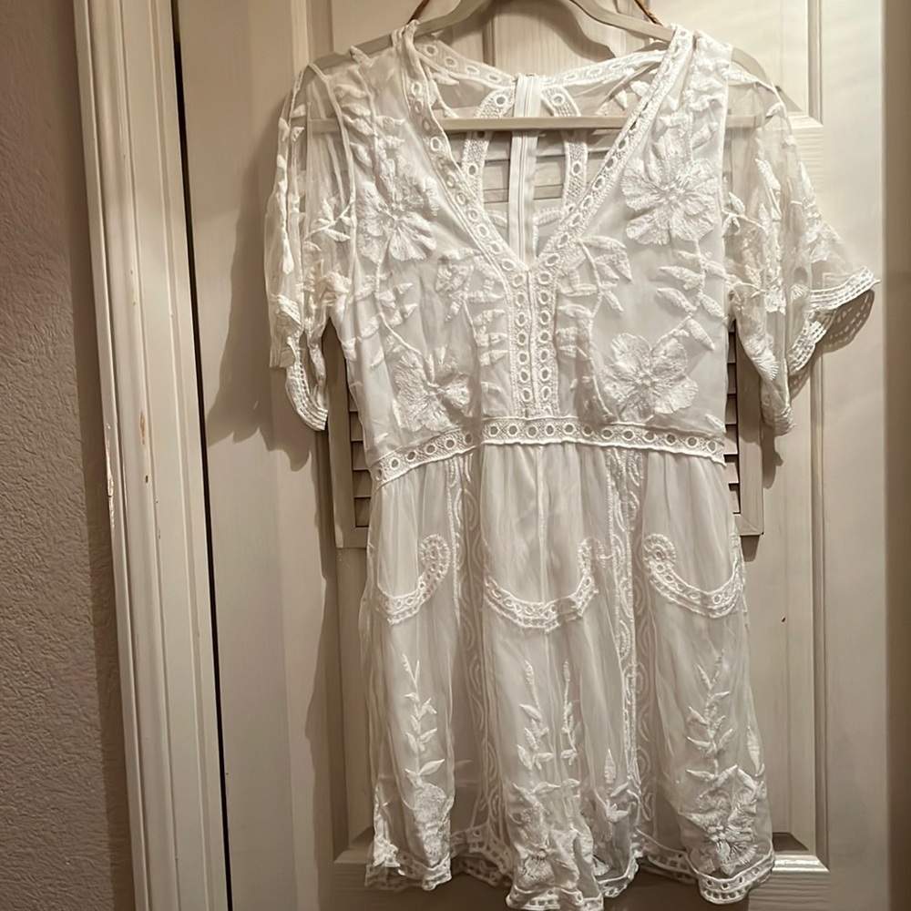 Super cute white lace romper. Size medium. No tags.